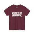 White block lettering on a dark t-shirt reading WELCOME TO THE ART OF MUSIC, with a smaller line beneath saying Physics is next door and an arrow pointing right