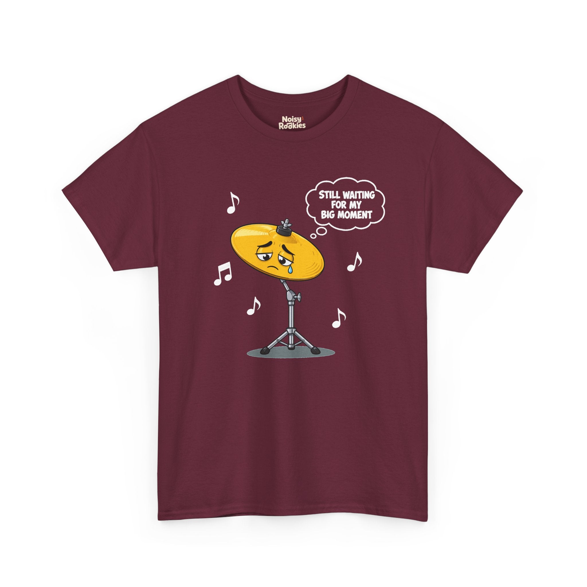 Dark-shirt design of a sad cartoon cymbal on a stand with a single tear, a thought bubble reading Still Waiting for My Big Moment, surrounded by music notes.