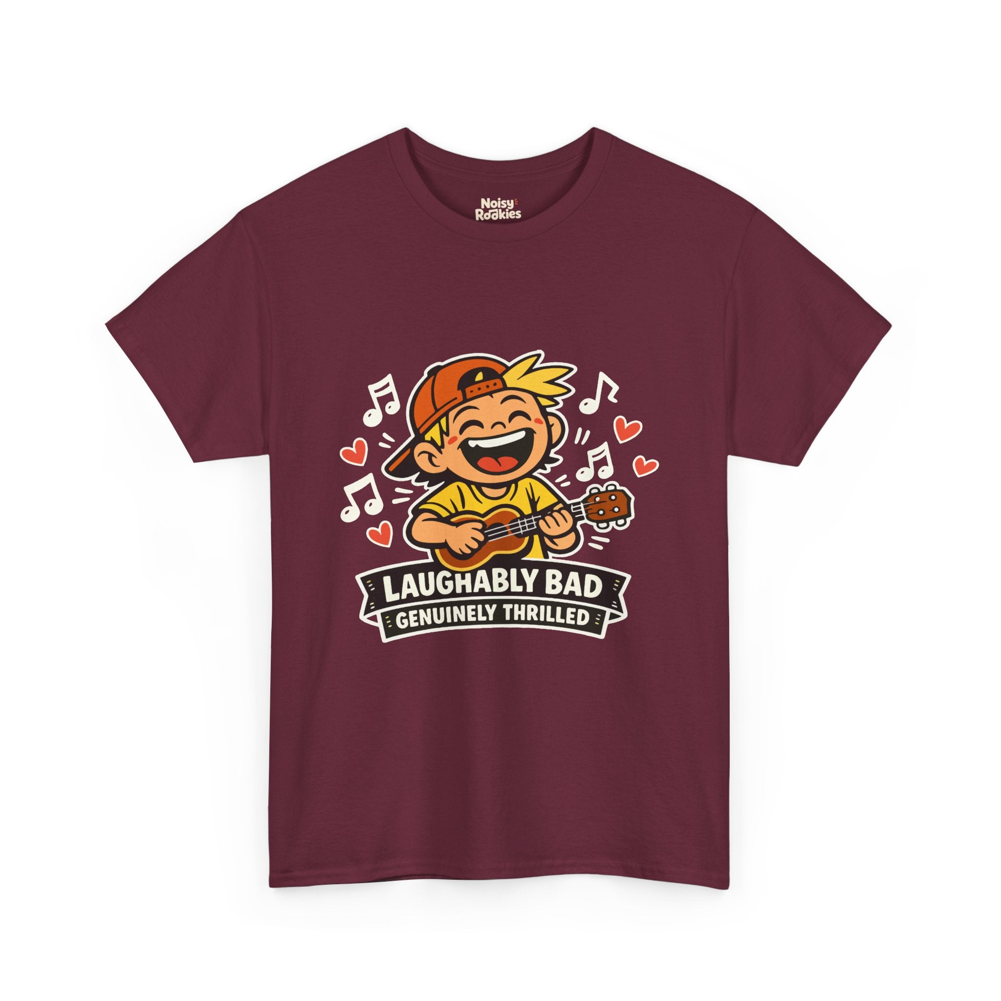 Dark-shirt design of a beaming cartoon kid in a backward cap strumming a ukulele, surrounded by music notes and hearts, over a banner reading Laughably Bad Genuinely Thrilled.